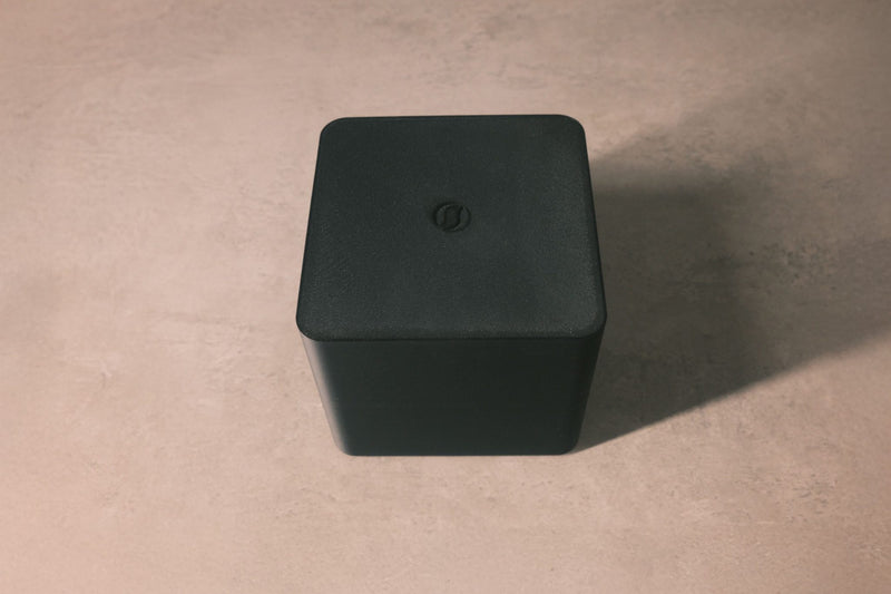 SteinMusic Ground Cube – black ground box on table, minimalist studio shot